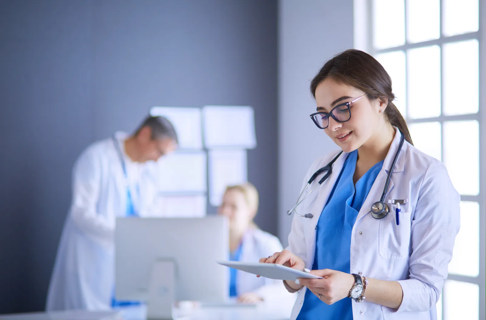 Doctor using a tablet in a hospital lobby