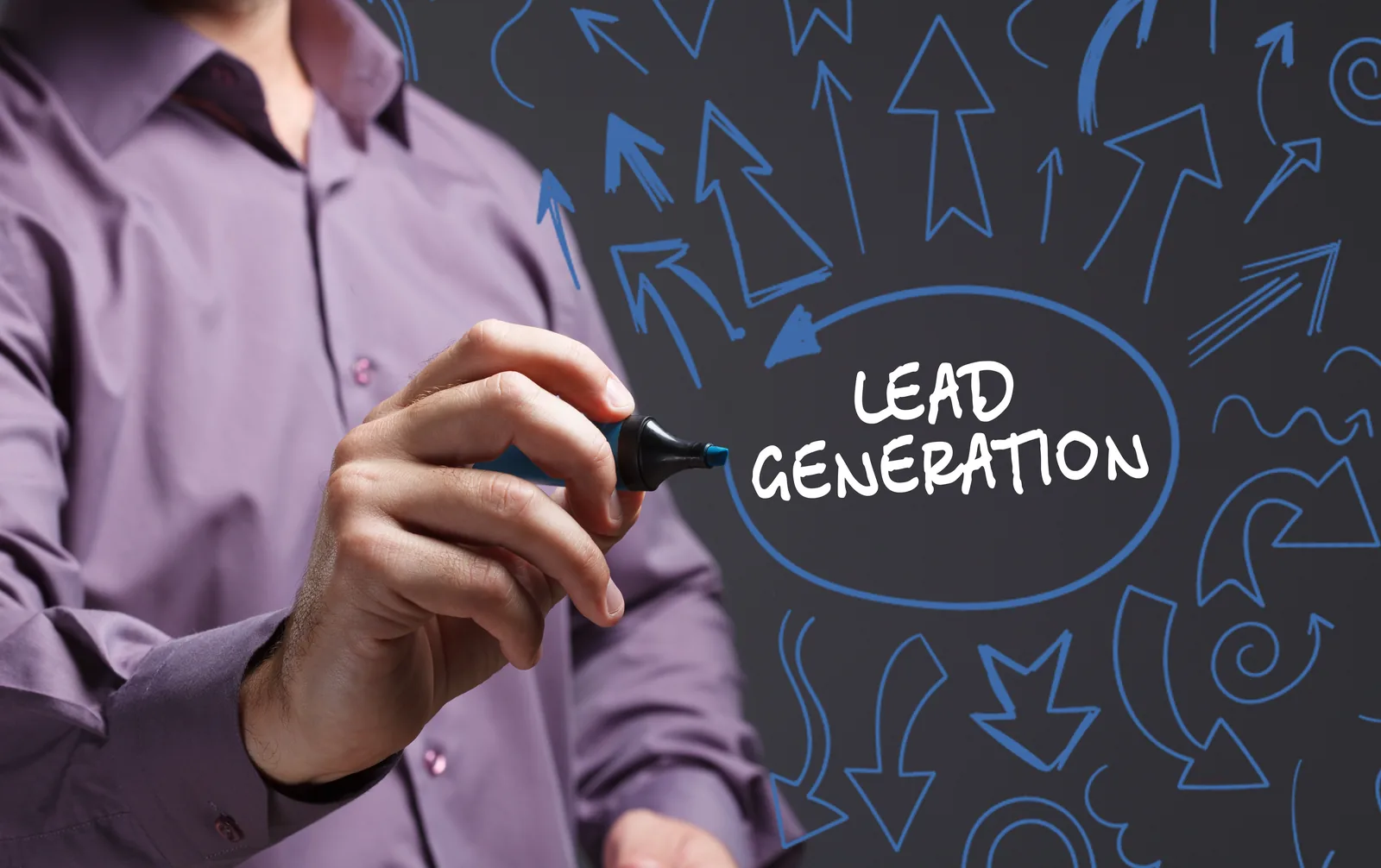 Marketer sketching a lead generation plan on a dark board
