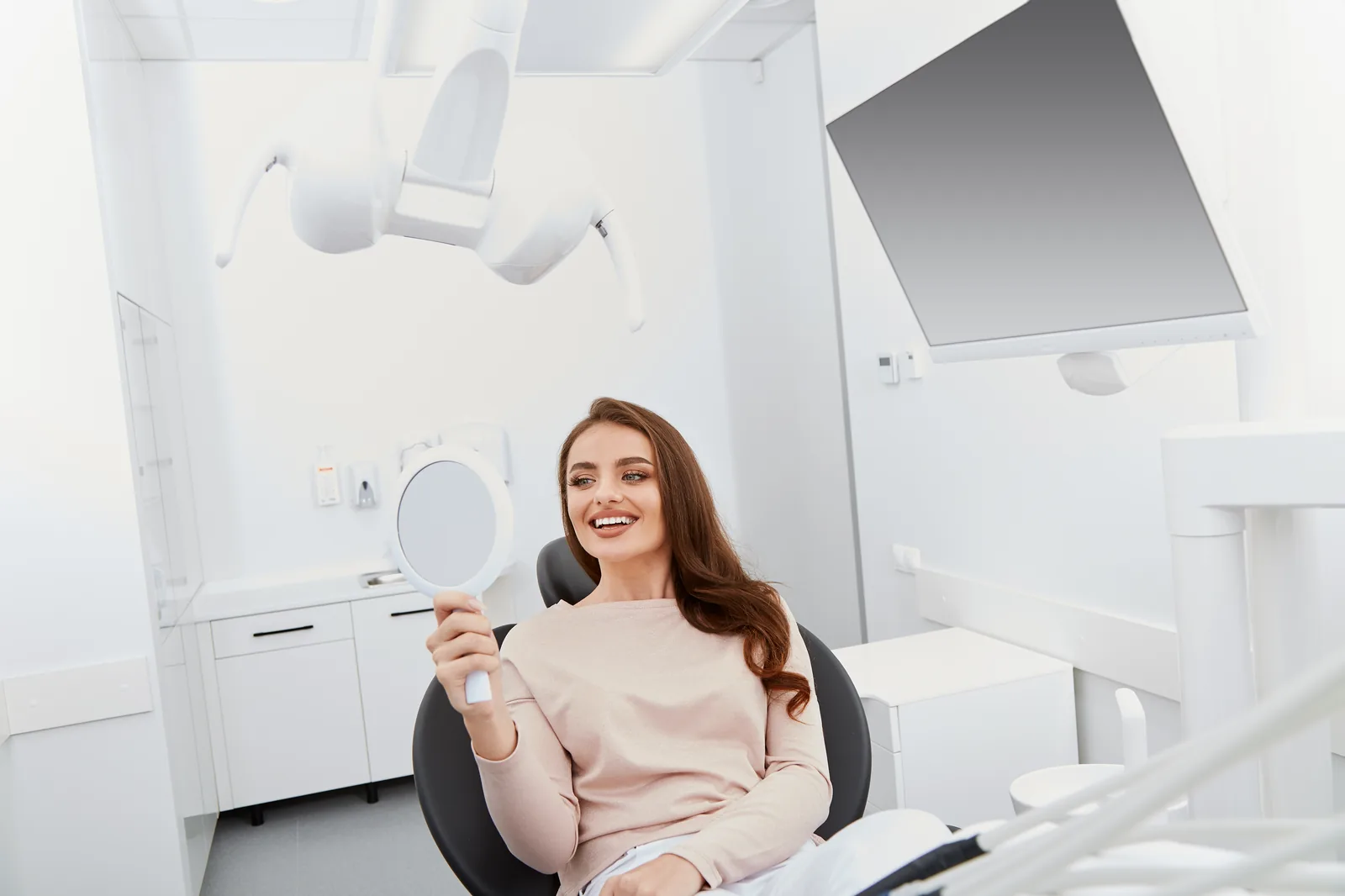 Smiling patient in a modern, welcoming dental practice