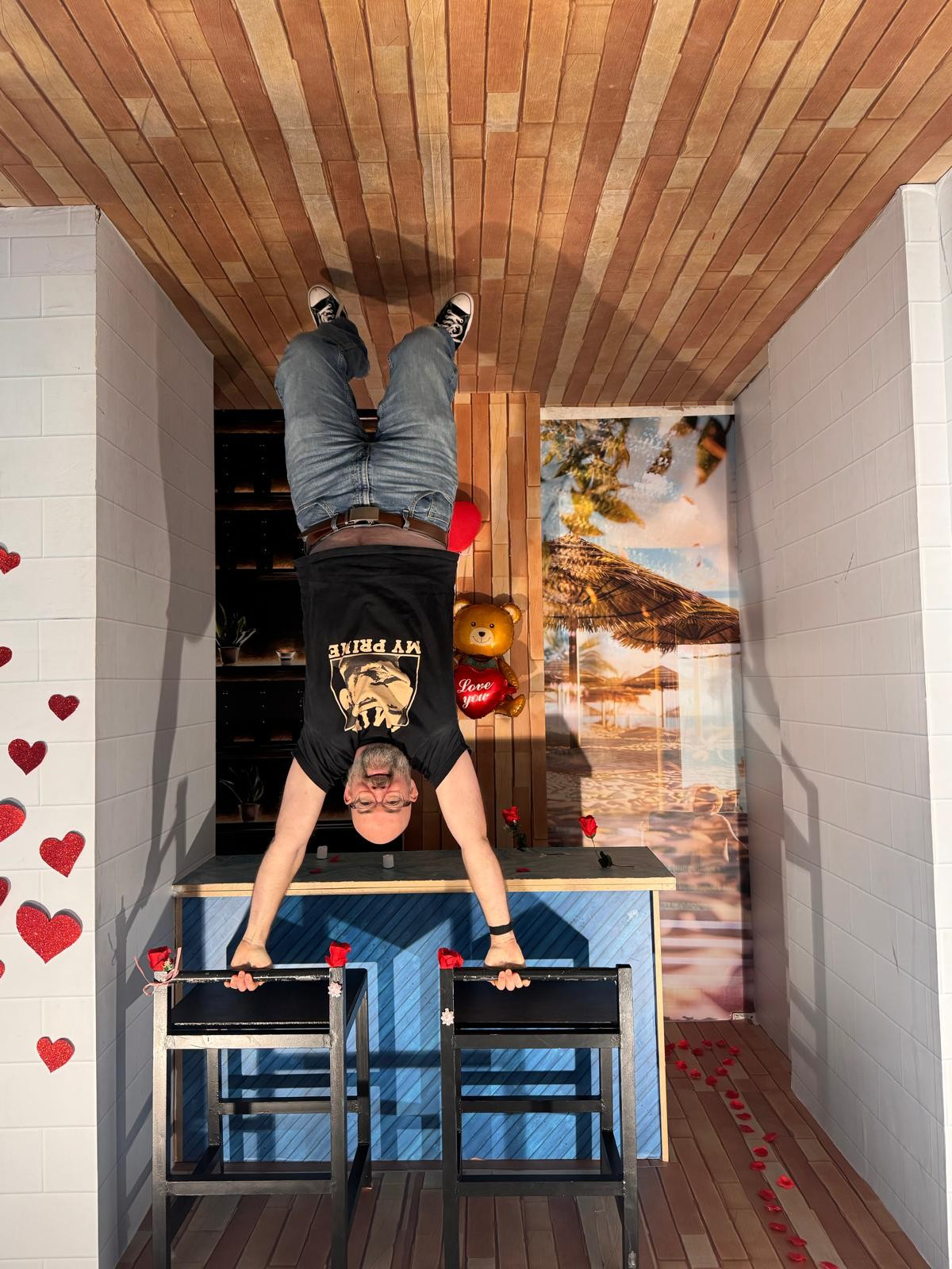 an image of tom cairns looking like he is holding himself up on the backs of two chairs